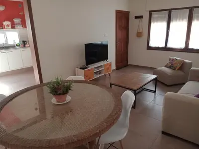 a living room with a table and a couch at Casa verde - cerca Hospital Privado y Quality in Cordoba