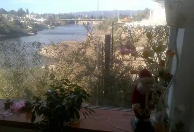 a santa clause sitting in a window with a view of a river at Alquiler Temporal desde febrero in Villa Carlos Paz