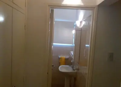 a white bathroom with a sink and a mirror at Alquiler Temporal desde febrero in Villa Carlos Paz