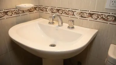 a white sink in a bathroom with at Lugones Park View in Cordoba