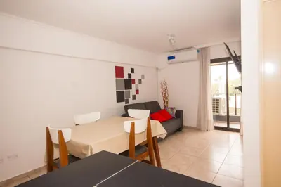 a living room with a table and a couch at Lugones Park View in Cordoba