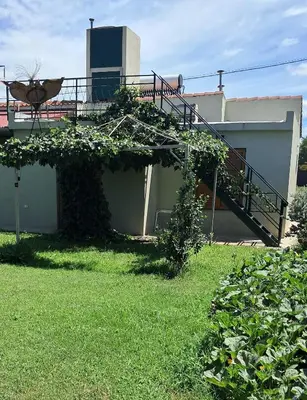 a house with a staircase on the side of it at Departamento Interno, Barrio Universidad in Río Cuarto