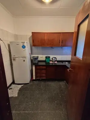 a kitchen with a white refrigerator and wooden cabinets at Salguero Centric Apartament D4 in Cordoba