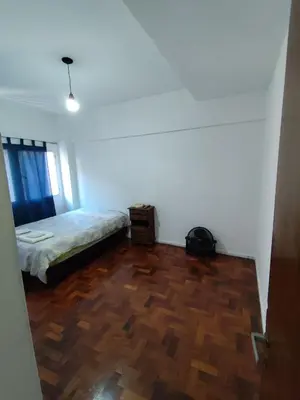 a bedroom with a bed and a wooden floor at Salguero Centric Apartament D4 in Cordoba