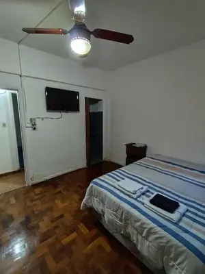 a bedroom with a bed and a flat screen tv at Salguero Centric Apartament D4 in Cordoba