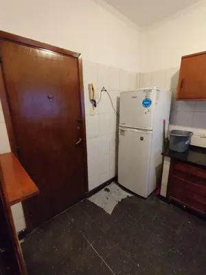 a small kitchen with a refrigerator and a telephone at Salguero Centric Apartament D4 in Cordoba
