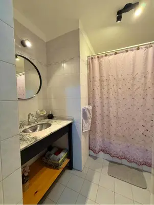 a bathroom with a sink and a shower curtain at Cordoba, estadio Kempes, Cerro de las Rosas, Urca, Chateau, Siglo21, Aeropuerto in Cordoba