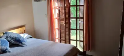 a bedroom with a bed and an open window at Cabaña Inti Huafi in Arroyo de Los Patos