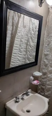 a bathroom with a sink and a mirror at Cabaña Inti Huafi in Arroyo de Los Patos