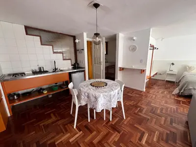a kitchen with a table and chairs in a room at Departamento Orange - Piso 3 Laprida Once in Cordoba