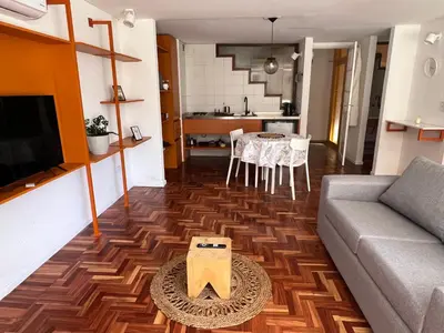 a living room with a couch and a table at Departamento Orange - Piso 3 Laprida Once in Cordoba