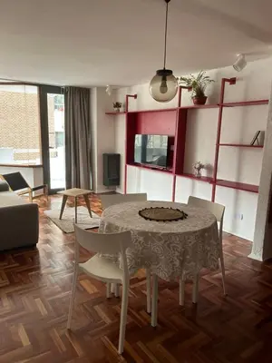 a living room with a table and chairs at Departamento Red - Piso 2 Laprida Once in Cordoba