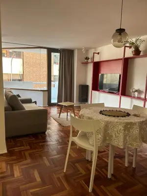 a living room with a table and a couch at Departamento Red - Piso 2 Laprida Once in Cordoba
