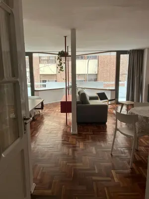 a living room with a couch and a table at Departamento Red - Piso 2 Laprida Once in Cordoba
