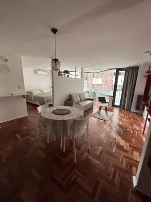 a living room with a table and a couch at Departamento Red - Piso 2 Laprida Once in Cordoba