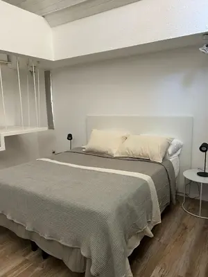 a bedroom with a large bed in a room at Departamento Duplex - Piso 4 Laprida Once in Cordoba