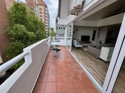 a balcony with a view of a living room at Departamento Duplex - Piso 4 Laprida Once in Cordoba