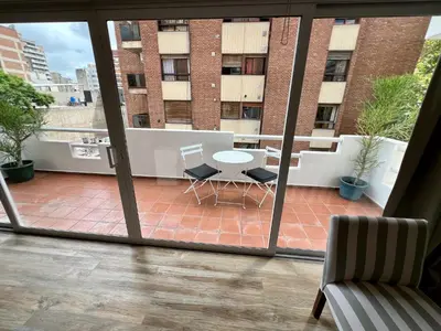 a view of a balcony with a table and chairs at Departamento Duplex - Piso 4 Laprida Once in Cordoba