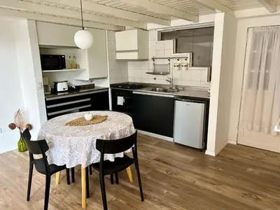 a kitchen with a table and chairs in a room at Departamento Duplex - Piso 4 Laprida Once in Cordoba