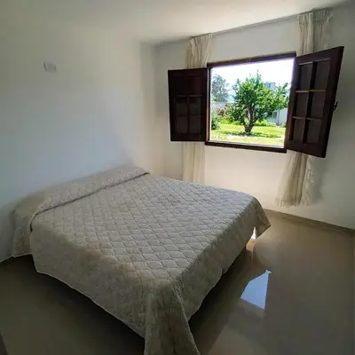 a bedroom with a bed and a window at Casa en Villa Carlos Paz con pileta y vista al Lago IG alquilervillacarlospaz in Villa Carlos Paz