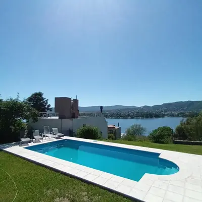 a swimming pool with a view of the water at Casa en Villa Carlos Paz con pileta y vista al Lago IG alquilervillacarlospaz in Villa Carlos Paz