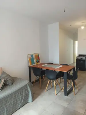 a room with a table and chairs and a bed at Apartamento Alto Alberdi in Cordoba