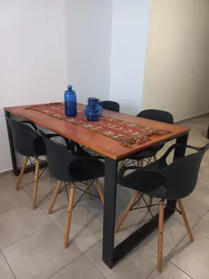 a wooden table with chairs and blue vases on it at Apartamento Alto Alberdi in Cordoba