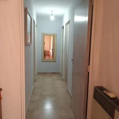 a hallway with a mirror on the wall and a room at Parques del Chateau in Cordoba