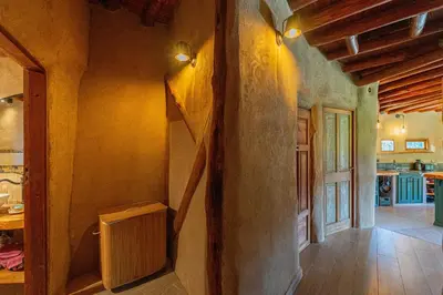 a kitchen with a stairway in a house at Terracota Eco-Casa Intiyaco 6 Pax in Atos Pampa