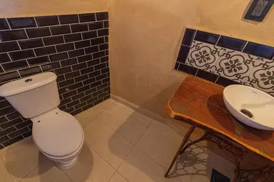 a bathroom with a toilet and a sink at Terracota Eco-Casa Intiyaco 6 Pax in Atos Pampa