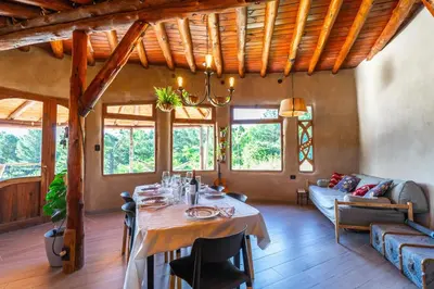 a dining room with a table and a couch at Terracota Eco-Casa Intiyaco 6 Pax in Atos Pampa