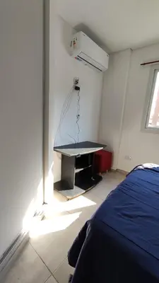 a bedroom with a bed and a desk in a room at DeRest - Barrio General Paz in Cordoba