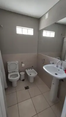 a bathroom with a toilet and a sink at DeRest - Barrio General Paz in Cordoba