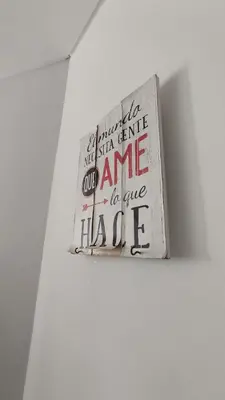 a sign is hanging on a white wall at DeRest - Barrio General Paz in Cordoba