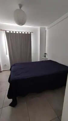 a bedroom with a blue bed and a window at DeRest - Barrio General Paz in Cordoba