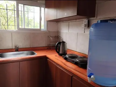 a kitchen with a sink and a counter top with a stove at Cabaña Economica en Bialet Massé a 9 km de Cosquín in Bialet Massé