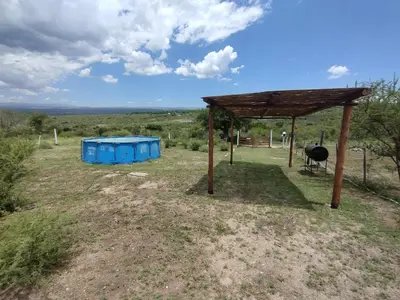 a pavilion and two blue containers in a field at Cabaña Economica en Bialet Massé a 9 km de Cosquín in Bialet Massé