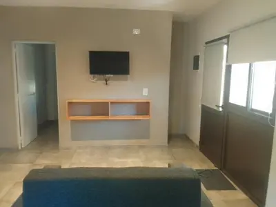 a living room with a tv and a couch at Apart Ladera Sur in Arroyo de Los Patos