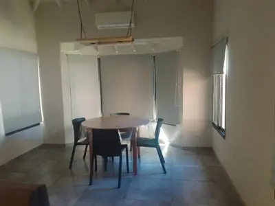 a dining room with a table and chairs at Apart Ladera Sur in Arroyo de Los Patos