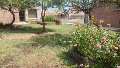 a garden with a bunch of flowers in a yard at Apart Ladera Sur in Arroyo de Los Patos