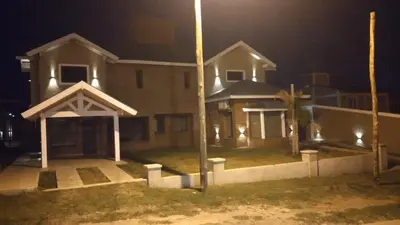 a large house at night with a street light at Apart Ladera Sur in Arroyo de Los Patos