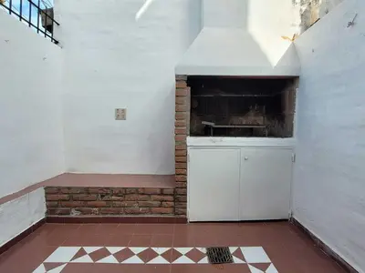 a kitchen with a stove and a brick wall at Casa para 5 Personas en Villa Cabrera con Garage in Cordoba
