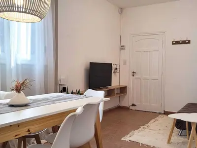 a dining room with a table and chairs and a television at Casa para 5 Personas en Villa Cabrera con Garage in Cordoba