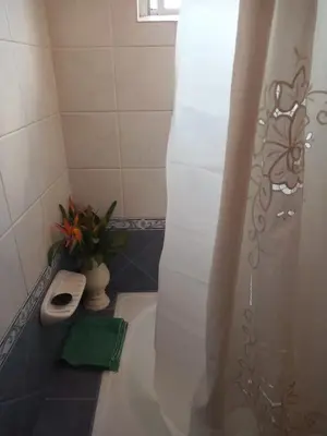 a bathroom with a toilet and a shower curtain at Casa Bela in Villa Carlos Paz