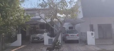 a car parked in front of a house with a fence at Casa Bela in Villa Carlos Paz