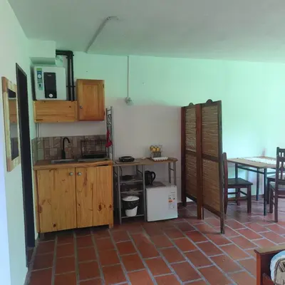 a kitchen with wooden cabinets and a table at Departamento interno Excelente ubicación in Alta Gracia