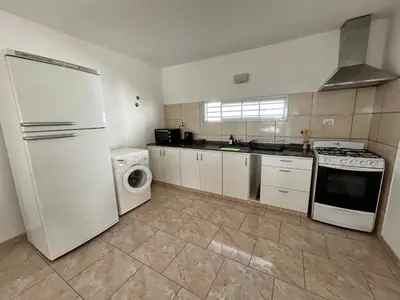 a kitchen with a white refrigerator and a washer and dryer at Río segundo in Río Segundo