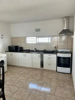 a kitchen with white cabinets and a stove at Río segundo in Río Segundo
