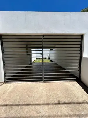 a garage door with a gate on the side of a building at Río segundo in Río Segundo