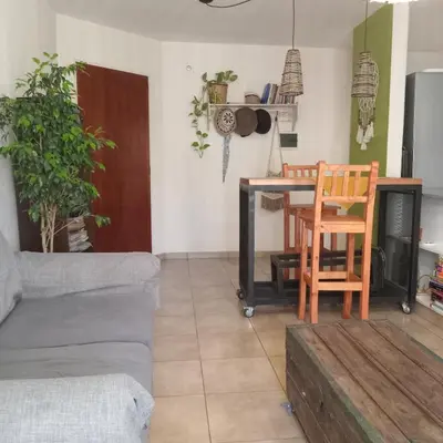a living room with a couch and a table at Parques del Chateau in Cordoba